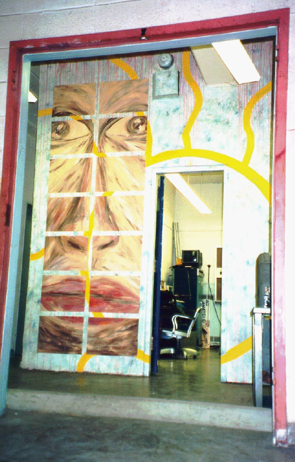 Door to the painted showing a face and stylized Sun.