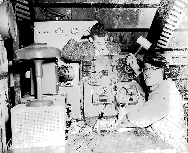 Al Feder seated in the old shack, 1950's (photo: Steve Aug, W3DEF) Yves (Al) Feder (W1UX) seated, with an old friend of his pretending to be a young novice