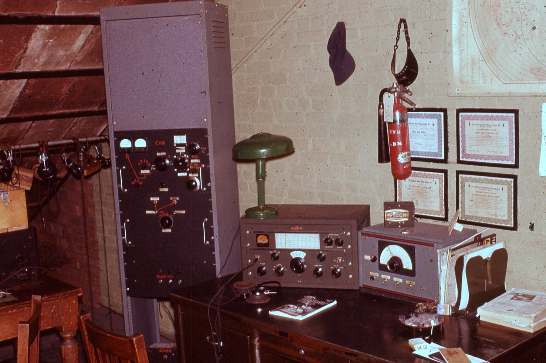 Photo of shack interior from January 1959 showing operating desk with radio equipment (unknown).