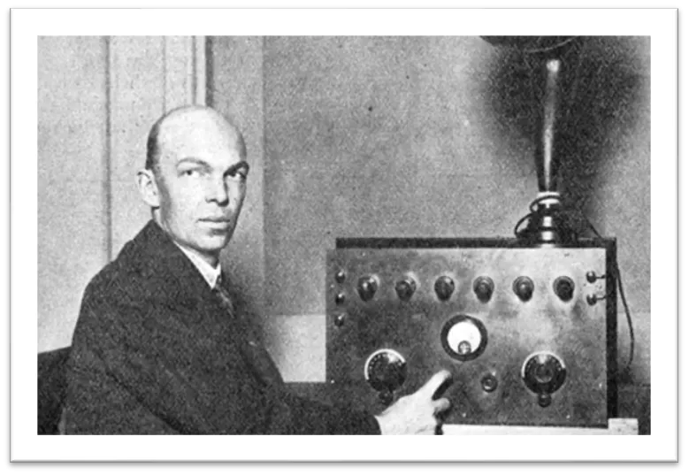 Photo of Armstrong in front of his radio receiver